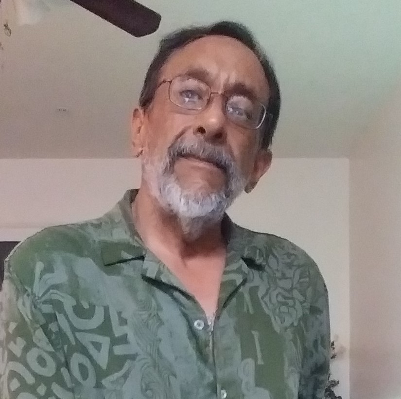 photo of middle-aged man with glasses and a white beard wearing a green shirt